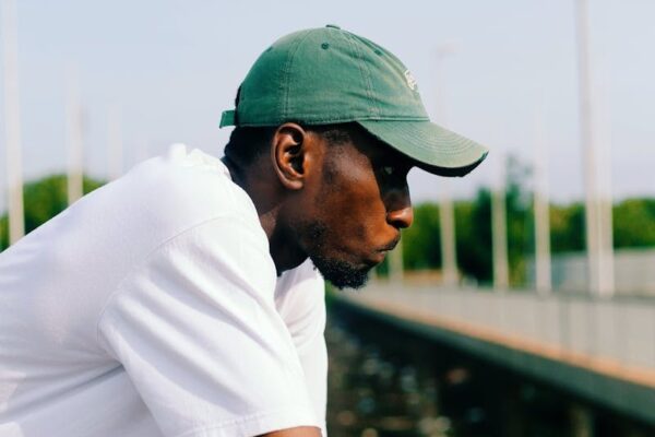 black man looking over rail